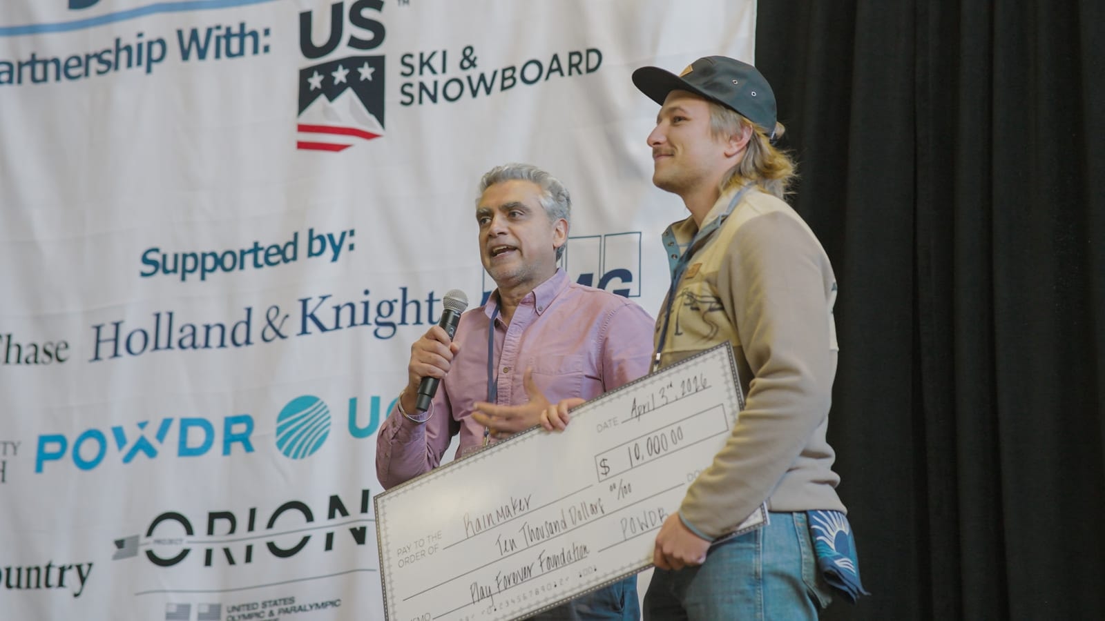 Rainmaker accepting the POWDR award on stage at Progression 2026